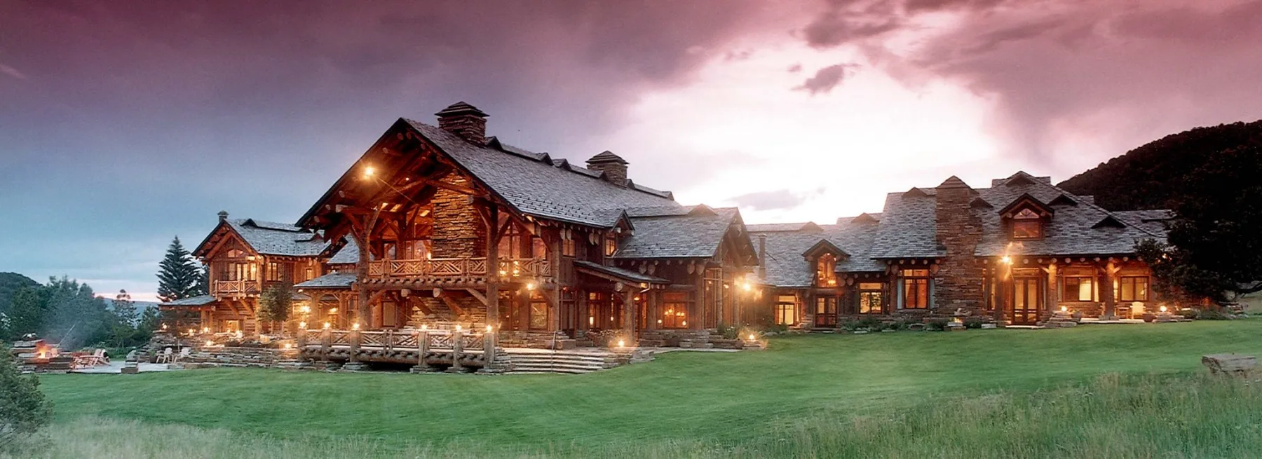 A five-star mountain lodge at dusk hosting an executive leadership retreat