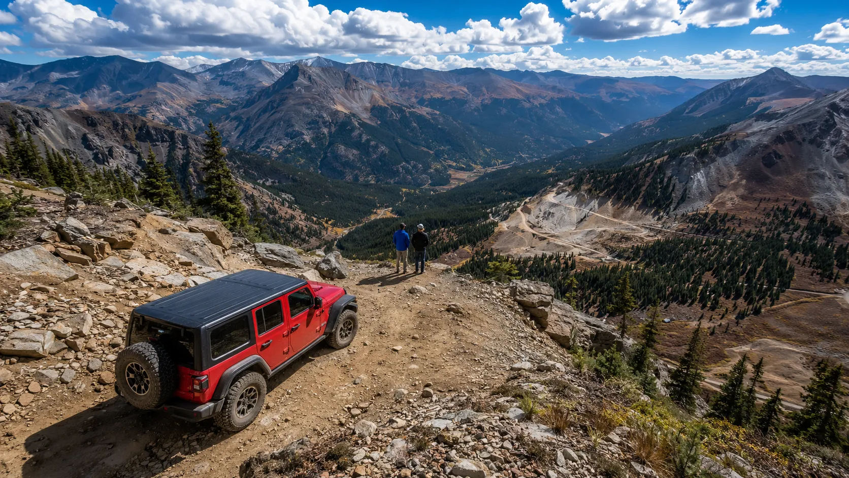 A Jeep on a rocky shelf road high in the Colorado Rockies, two executives looking out over the valley — the Off-Road Immersion leadership offsite.