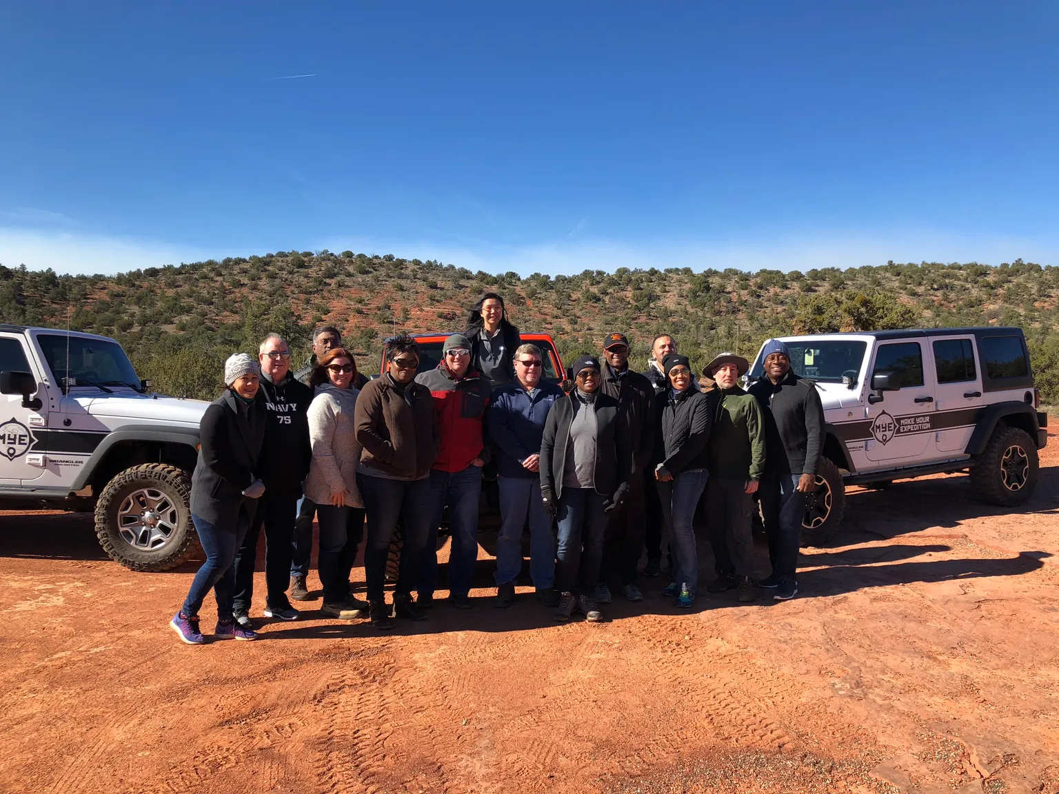 An executive team together on an off-road development day in the Sedona red rock.